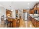 Spacious kitchen featuring wood cabinets, granite countertops, stainless steel appliances, and a large island with bar seating at 968 Woodtrace Ln, Auburn, GA 30011