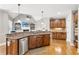 Open-concept kitchen with stainless steel appliances and dark wooden cabinets with granite countertops at 968 Woodtrace Ln, Auburn, GA 30011