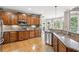 Kitchen with wooden cabinetry, granite countertops, stainless steel appliances and eat-in nook at 968 Woodtrace Ln, Auburn, GA 30011