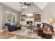 Cozy living room with a vaulted ceiling, fireplace, built-in shelves, and comfortable seating at 968 Woodtrace Ln, Auburn, GA 30011