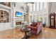 Cozy living room with hardwood floors, built-in bookshelves, and a stone fireplace at 968 Woodtrace Ln, Auburn, GA 30011