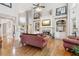 Bright living room with hardwood floors, a fireplace, built-in shelving, and a soaring ceiling at 968 Woodtrace Ln, Auburn, GA 30011