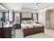 The main bedroom is spacious, with a ceiling fan, windows, and a plush king-sized bed at 968 Woodtrace Ln, Auburn, GA 30011
