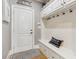 Welcoming mudroom features built-in storage bench, hooks, and a convenient entry door for easy access at 968 Woodtrace Ln, Auburn, GA 30011