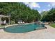 Inviting backyard pool with a waterfall feature and lush landscaping for a serene outdoor experience at 968 Woodtrace Ln, Auburn, GA 30011
