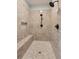 Modern shower featuring neutral toned tile and a built-in bench at 968 Woodtrace Ln, Auburn, GA 30011