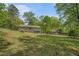 Expansive backyard with lush greenery, mature trees, and a fenced perimeter, creating a private outdoor space at 10 Powder Dr, Dallas, GA 30157