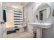 Bathroom with tile floors, a shower-tub combination, and pedestal sink at 10 Powder Dr, Dallas, GA 30157