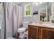 Cozy bathroom featuring a vanity with wooden cabinets, white countertops, and a framed mirror at 10 Powder Dr, Dallas, GA 30157