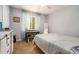 Well-lit bedroom featuring a bright window, desk, and light carpet at 10 Powder Dr, Dallas, GA 30157