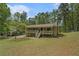 Well-maintained home on a large lot with mature trees and a covered front porch at 10 Powder Dr, Dallas, GA 30157