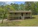 Charming single-story home featuring a covered front porch, green lawn, and mature trees at 10 Powder Dr, Dallas, GA 30157