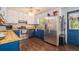 Well-lit kitchen with stainless steel appliances, wood countertops, and white and blue cabinetry at 10 Powder Dr, Dallas, GA 30157