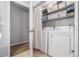Cozy laundry area with washer, dryer, shelving, and overhead storage at 10 Powder Dr, Dallas, GA 30157
