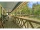 View of the inviting covered porch with wooden railings and a view of the landscaped yard at 10 Powder Dr, Dallas, GA 30157