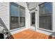 Cozy back patio with wood flooring and access to the yard at 209 Phillips Ln, Alpharetta, GA 30009