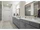 Modern main bathroom featuring double sinks, a stone tile floor and great lighting at 209 Phillips Ln, Alpharetta, GA 30009