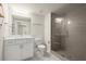 Bright bathroom with quartz countertop vanity and tiled glass-enclosed shower at 209 Phillips Ln, Alpharetta, GA 30009