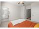 Bright bedroom with ensuite bathroom access, ceiling fan, and neutral decor at 209 Phillips Ln, Alpharetta, GA 30009