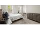 Bedroom with natural light from two windows, carpeted floor, and metal dresser at 209 Phillips Ln, Alpharetta, GA 30009