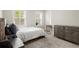 Well-lit bedroom featuring a bed, end tables, and windows offering natural light at 209 Phillips Ln, Alpharetta, GA 30009