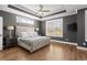 Luxurious main bedroom with trey ceiling, hardwood floors and ample natural light at 209 Phillips Ln, Alpharetta, GA 30009