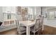 Bright dining room features a wooden table with chairs next to white kitchen at 209 Phillips Ln, Alpharetta, GA 30009