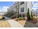 Beautiful townhome community with brick accents, wrought iron details and sidewalks at 209 Phillips Ln, Alpharetta, GA 30009