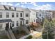 Attractive townhomes featuring black trim, brick bases, and landscaped surroundings at 209 Phillips Ln, Alpharetta, GA 30009