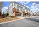 Modern townhomes featuring private balconies, brick accents, and attached garages in a well-maintained community at 209 Phillips Ln, Alpharetta, GA 30009
