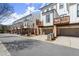 Beautiful street view of modern townhomes with drive-under garages and private wooden balconies at 209 Phillips Ln, Alpharetta, GA 30009