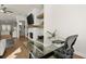 Bright home office with sleek glass desk and white brick fireplace, adding modern appeal at 209 Phillips Ln, Alpharetta, GA 30009