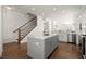 Bright kitchen features a gray island, stainless appliances and hardwood floors at 209 Phillips Ln, Alpharetta, GA 30009
