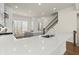 Well lit kitchen features a gray island, granite countertop, stainless sink and hardwood floors at 209 Phillips Ln, Alpharetta, GA 30009