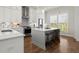 Stylish kitchen with stainless steel appliances, island, and white subway tile backsplash at 209 Phillips Ln, Alpharetta, GA 30009