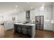 Bright kitchen with island seating, stainless appliances, and sleek white cabinetry at 209 Phillips Ln, Alpharetta, GA 30009