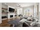Spacious living room features a brick fireplace with wood accents and comfortable seating at 209 Phillips Ln, Alpharetta, GA 30009