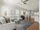 Bright, open living area featuring a large sectional sofa, hardwood floors, and seamless flow into the dining space at 209 Phillips Ln, Alpharetta, GA 30009