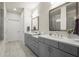 Well-lit main bathroom featuring double sinks, modern fixtures, and a walk-in shower at 209 Phillips Ln, Alpharetta, GA 30009