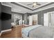 Large main bedroom with ceiling fan, huge mirror, TV, and access to ensuite bathroom at 209 Phillips Ln, Alpharetta, GA 30009