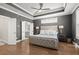 Beautiful main bedroom featuring a tray ceiling, hardwood floors, and ensuite bathroom at 209 Phillips Ln, Alpharetta, GA 30009