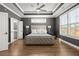 Bright main bedroom showcasing hardwood floors, tray ceilings, and modern decor at 209 Phillips Ln, Alpharetta, GA 30009