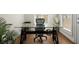 Office space has a glass top desk with industrial style base and a large window at 209 Phillips Ln, Alpharetta, GA 30009