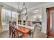 Bright dining area with wood floors, trim, curtains, and a built in china cabinet at 4040 Grandview Manor Dr, Cumming, GA 30028