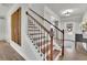 Elegant foyer with hardwood staircase, decorative accents, and a welcoming entrance at 4040 Grandview Manor Dr, Cumming, GA 30028