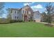 Charming two-story home with blue siding, brick accents, and a well-maintained lawn at 4040 Grandview Manor Dr, Cumming, GA 30028