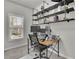 Home office area with a window and an industrial style desk with dual monitors at 4040 Grandview Manor Dr, Cumming, GA 30028