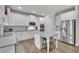 Modern kitchen with white cabinets, stainless steel appliances, and a center island at 4040 Grandview Manor Dr, Cumming, GA 30028