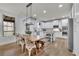 Open-concept kitchen with stainless appliances, kitchen island, and adjacent dining space at 4040 Grandview Manor Dr, Cumming, GA 30028