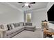 Comfortable living room featuring an ample gray sofa, large window, and a ceiling fan at 4040 Grandview Manor Dr, Cumming, GA 30028